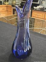 Full view of cobalt blue glass vase standing upright