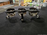 Full view of metal stand with three mosaic glass cups
