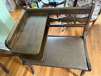 Full view of wooden telephone bench showing seat, side table, and shelf