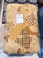 Top view showing patterned upholstery and note card