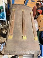 Top view showing three wooden slats, canvas surface and brass corner plates