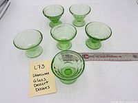 All six uranium glass dessert bowls arranged top view with ruler for scale