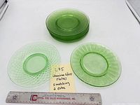 Stack of plates with two patterns visible alongside ruler and note