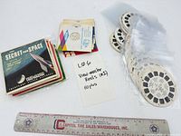 Overall lot with reels in sleeves, paper envelopes, ruler for scale