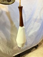 Full view of pendant showing white glass shade and teak stem