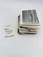Stack of vintage photos with note indicating 300 photos