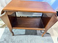 Front angled view of side table showing overall structure and shelf