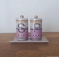 Front view of salt and pepper shakers on tray