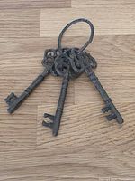 Front view of three cast iron skeleton keys on ring