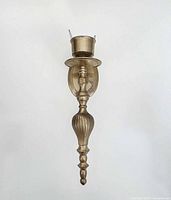 Front view of full brass candle sconce displaying overall design