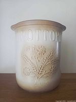 Front view of stoneware crock showing BROTTOPF text and motif