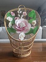 Front view of fan-shaped wicker basket with seashell flower bouquet