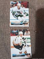 Front view of both hockey cards laid on fabric surface