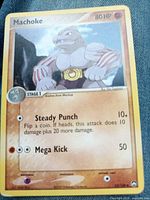Front of Machoke card on denim showing artwork, HP, attacks, card number