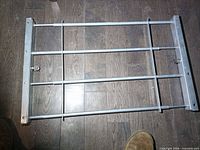 Full view of window security bar, showing expandable frame and bars