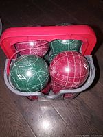 Top view of carrier showing four green and four red bocce balls