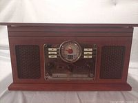 Front view of woodgrain turntable showing speakers and control panel