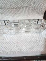 Top view of rectangular clear glass candle holder with three cups