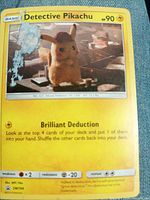 Front of Detective Pikachu promo card showing artwork, text, top-left peeling and residue