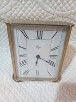 Front view of Ergo brass mantel/desk clock showing dial and Roman numerals