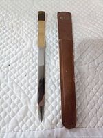 Letter opener and leather sheath side by side