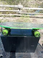 Side profile showing full skateboard with deck, trucks, wheels