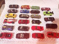 Top view of 25 Hot Wheels cars arranged in five rows
