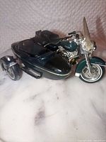 Front three-quarter view showing motorcycle, sidecar, windshield and color scheme