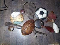 Front view of entire multi-sport wall sculpture showing all sports equipment shapes