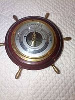 Front view of ship wheel barometer showing full design and materials