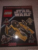 Front cover showing title, LEGO and Star Wars branding, graphic of Jedi Starfighter, note of 1000+ stickers
