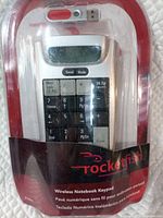 Front view of sealed Rocketfish wireless numeric keypad with USB receiver