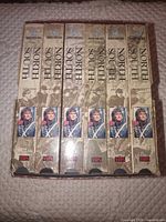 Front view of six VHS spines in box