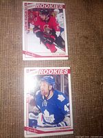 Fronts of both rookie cards showing players and team logos