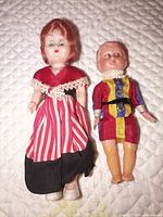 Both dolls full view on quilted surface