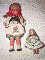 Front view of both dolls showing costumes and size comparison