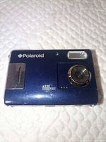 Front view of Polaroid a330 camera showing lens, flash, branding, scratches