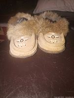 Front view of pair showing beadwork and fur trim