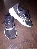 Left and right shoes angled side view showing uppers, midsoles and general condition