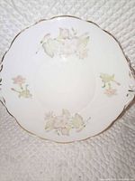 Full view of saucer front showing floral pattern and gold trim