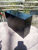 Front/side view showing glossy black finish
