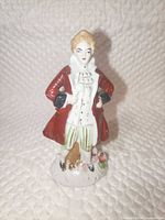 Front view of porcelain gentleman figurine showing attire and base detail
