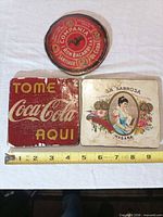 Overview of all three advertising pieces with ruler for scale