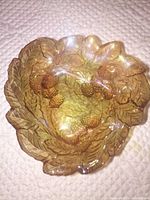 Top view of marigold carnival glass bowl showing raspberry pattern and iridescent finish