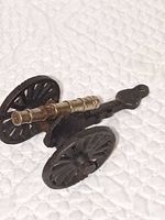 side view showing wheels, frame and brass barrel