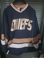 Front view of blue Chiefs hockey jersey showing lettering and striping