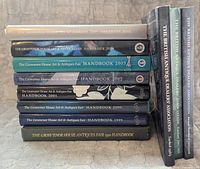 Spine view of all eleven books stacked to show titles and years