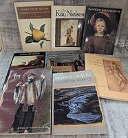 Front covers of seven visible books showing titles and artwork