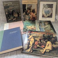 Front view of all eight art books, covers visible