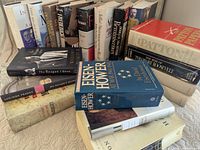 Angled shot of stacked and upright books showing titles and spines
